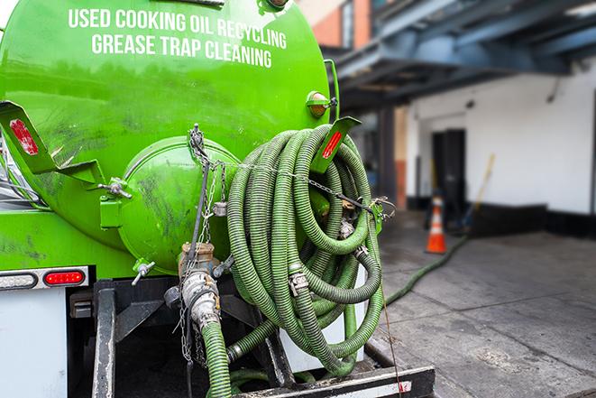 a technician pumping a grease trap in a commercial building in Union, OH